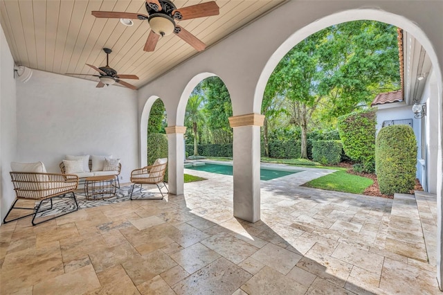 view of patio with a fenced in pool and ceiling fan