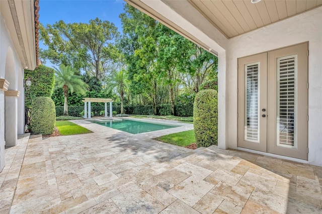 view of swimming pool featuring a pergola, a patio area, a fenced in pool, and french doors