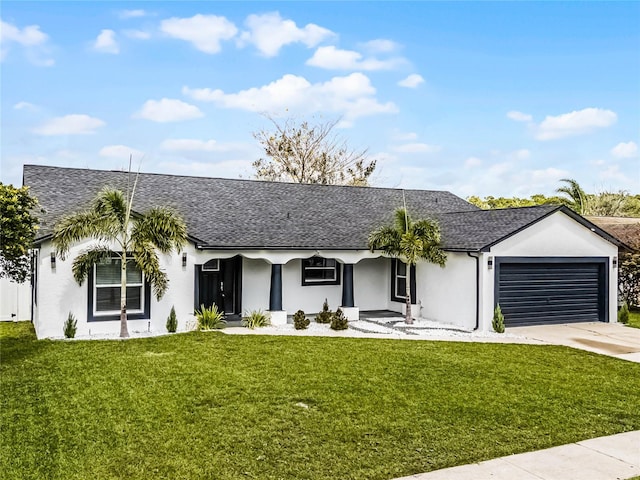 ranch-style home featuring concrete driveway, an attached garage, a front yard, and roof with shingles