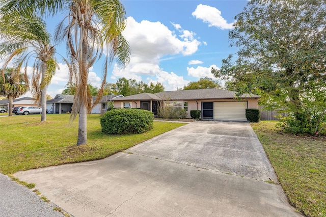 ranch-style home with a garage, concrete driveway, and a front lawn