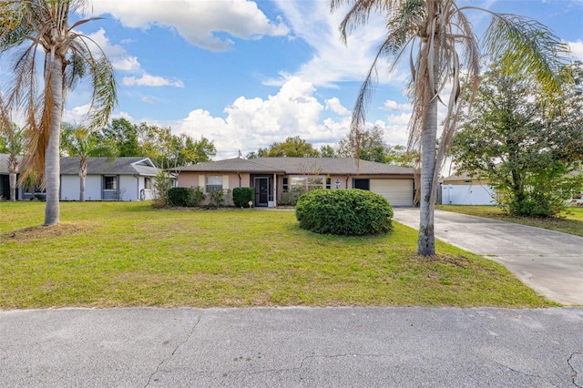 ranch-style house featuring a garage, driveway, a front lawn, and fence