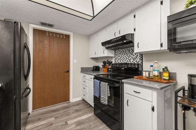 kitchen with black appliances, under cabinet range hood, a textured ceiling, white cabinetry, and light wood-type flooring