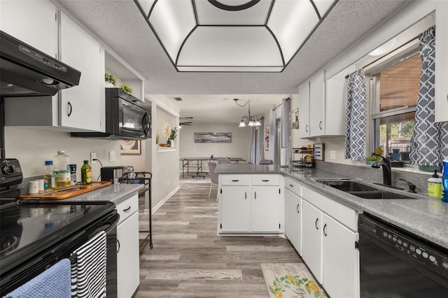 kitchen featuring white cabinetry, black appliances, extractor fan, and a sink