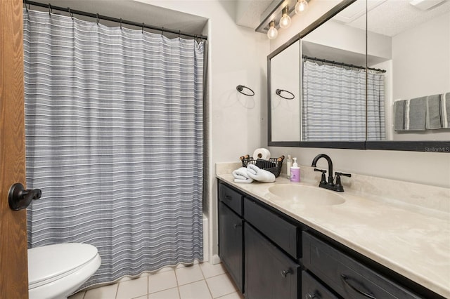 bathroom with vanity, a shower with curtain, a textured ceiling, tile patterned floors, and toilet