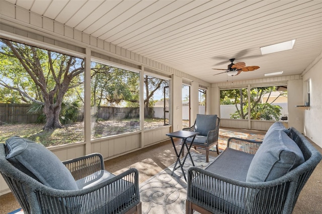 sunroom with a skylight and ceiling fan