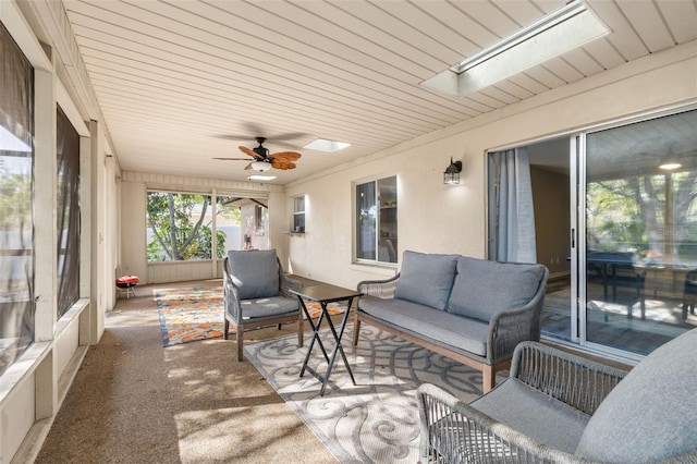 sunroom / solarium with a skylight and a ceiling fan