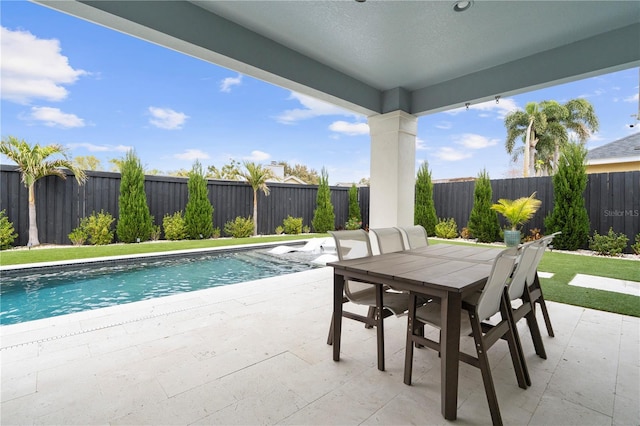 view of swimming pool with a patio area, outdoor dining space, a fenced in pool, and a fenced backyard