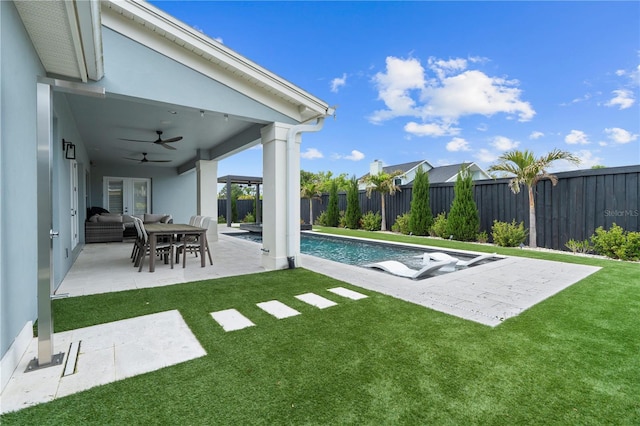 view of pool with a patio, a yard, a fenced backyard, and ceiling fan