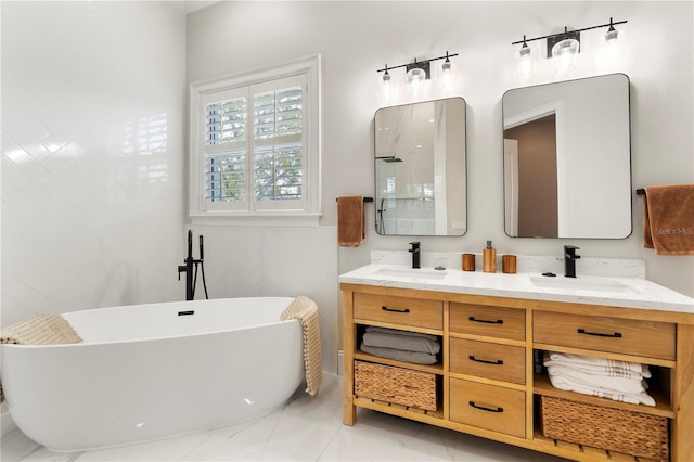 bathroom featuring a sink, a freestanding tub, and double vanity