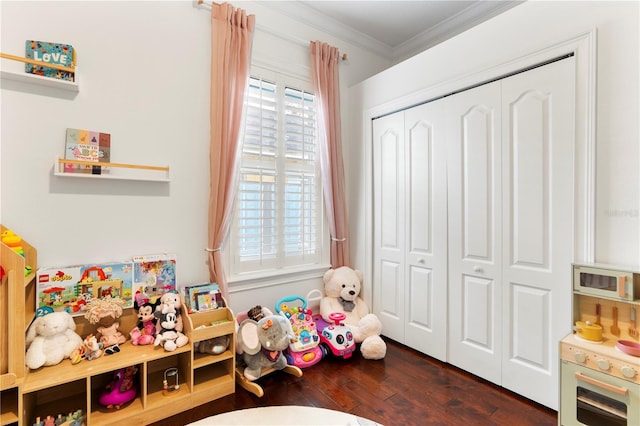 recreation room featuring hardwood / wood-style floors and ornamental molding