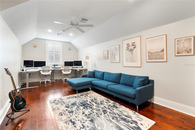 living area featuring hardwood / wood-style flooring, baseboards, visible vents, and lofted ceiling