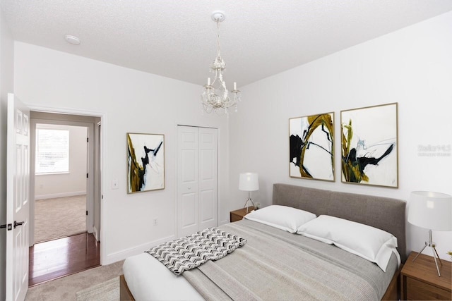 2217 Wekiva Reserve Blvd, Apopka, FL 32703 - bedroom with light colored carpet, a chandelier, a closet, and baseboards