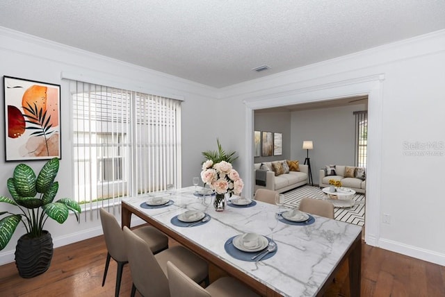 2217 Wekiva Reserve Blvd, Apopka, FL 32703 - dining room with dark wood-style flooring, ornamental molding, baseboards, and a textured ceiling