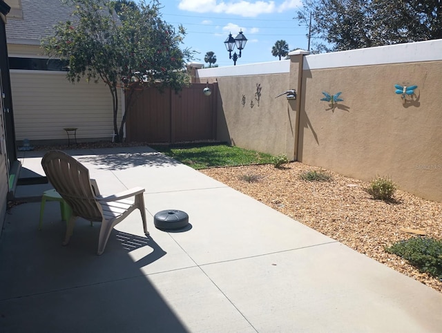 view of patio / terrace featuring a gate and fence