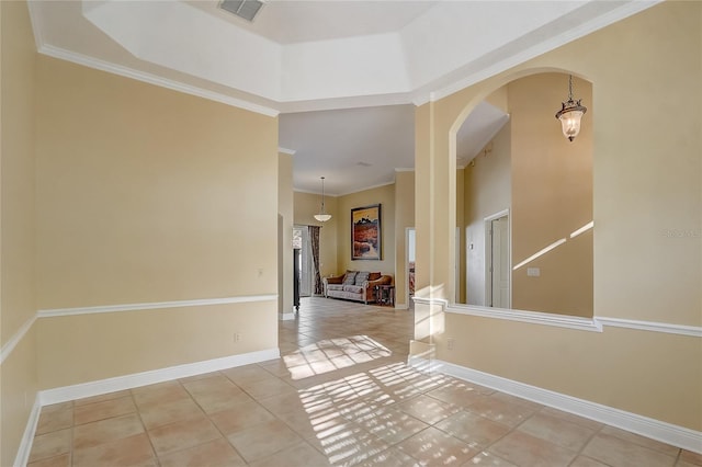 interior space with visible vents, ornamental molding, arched walkways, light tile patterned flooring, and baseboards