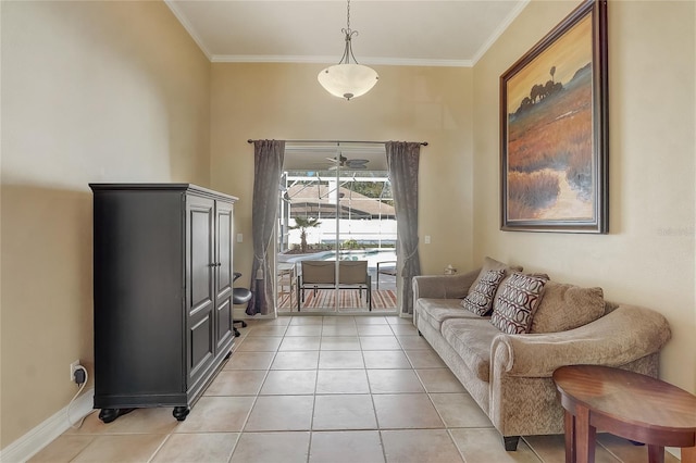 living area with crown molding, light tile patterned flooring, a ceiling fan, and baseboards