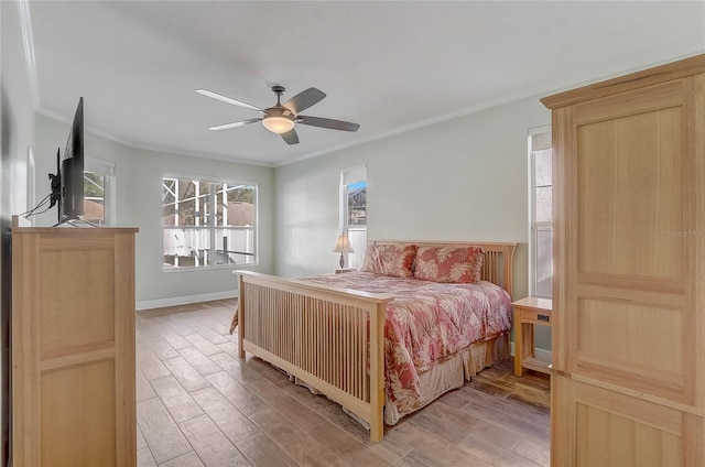 bedroom with ceiling fan, baseboards, light wood-style flooring, and ornamental molding