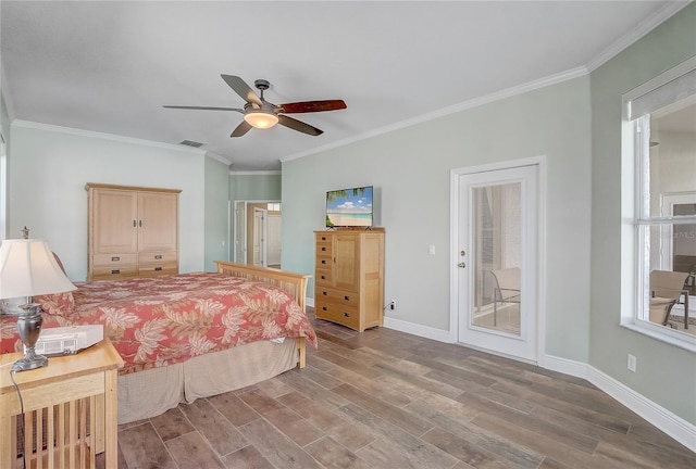 bedroom featuring visible vents, crown molding, baseboards, and wood finished floors