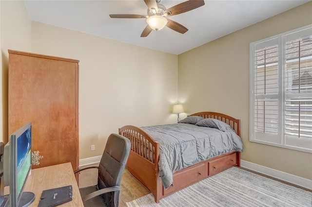 bedroom featuring a ceiling fan and baseboards