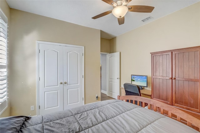 bedroom with a closet, visible vents, and ceiling fan