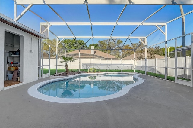 view of swimming pool with a lanai, a fenced in pool, a patio, and a fenced backyard