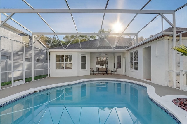 view of pool with glass enclosure, a patio area, and a fenced in pool