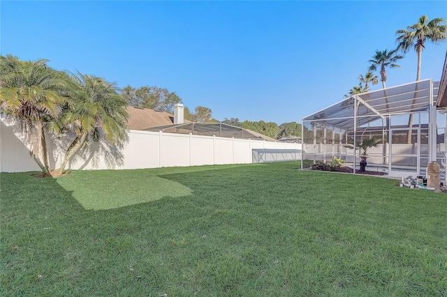 view of yard featuring a lanai and a fenced backyard