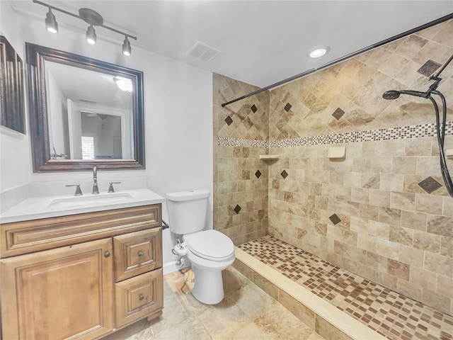 full bath featuring visible vents, tiled shower, toilet, and vanity