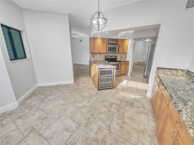 kitchen featuring visible vents, tasteful backsplash, wine cooler, appliances with stainless steel finishes, and light stone countertops