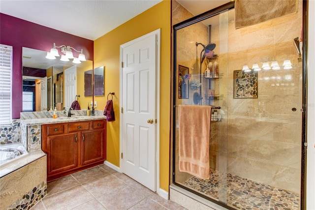 bathroom with vanity, a bath, a shower stall, and tile patterned flooring