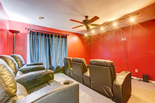 carpeted cinema room with baseboards, a textured ceiling, and ceiling fan