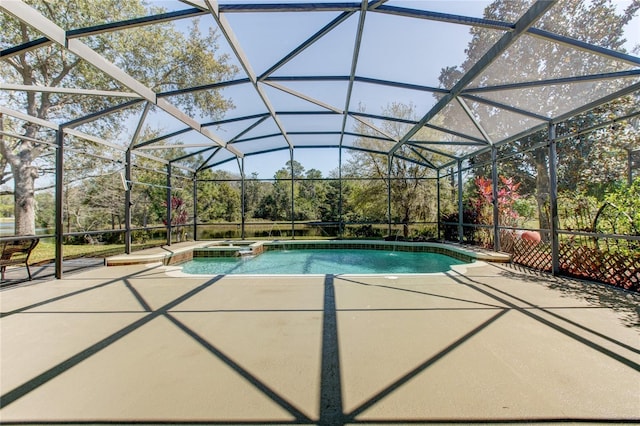 view of swimming pool featuring a pool with connected hot tub, a lanai, and a patio area