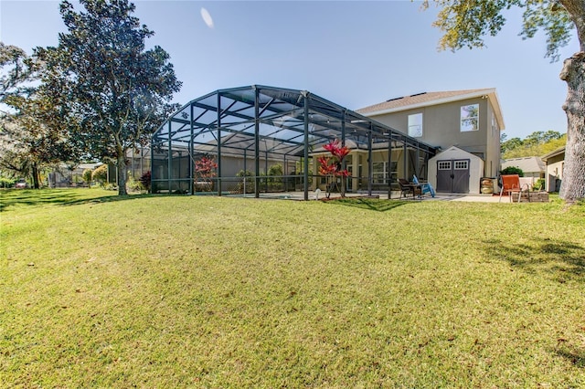 view of yard with an outbuilding, a patio area, a lanai, and a storage shed