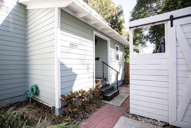 entrance to property featuring fence