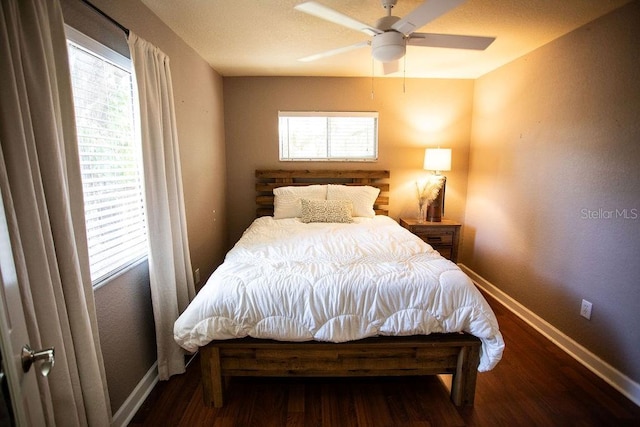 bedroom with ceiling fan, baseboards, and wood finished floors