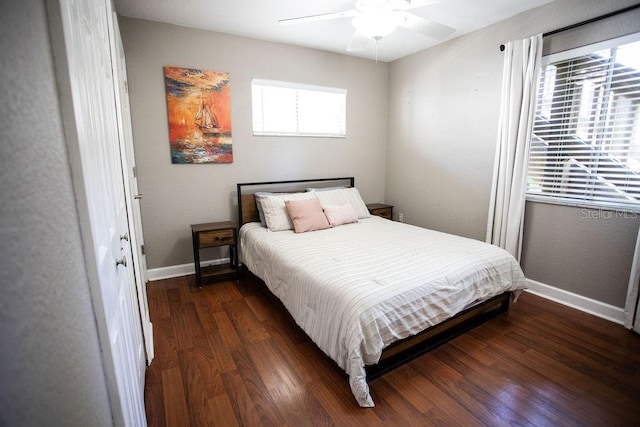 bedroom with a ceiling fan, baseboards, and wood finished floors