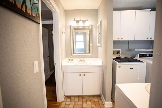 bathroom with separate washer and dryer and a textured wall