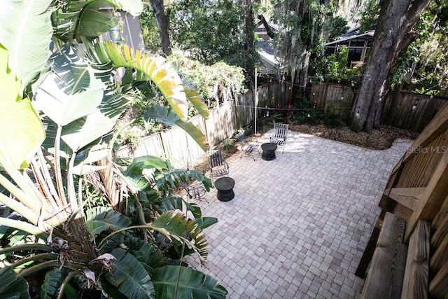 view of patio with a fenced backyard and an outdoor fire pit