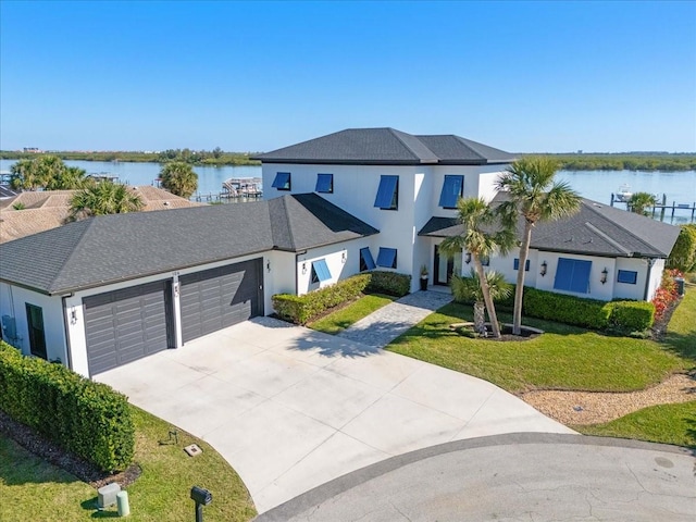 view of front of home featuring stucco siding, driveway, a front lawn, and a garage