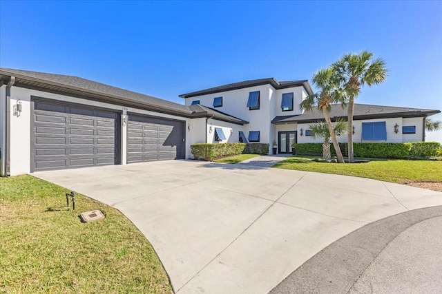 view of front of home with concrete driveway, an attached garage, a front yard, and stucco siding