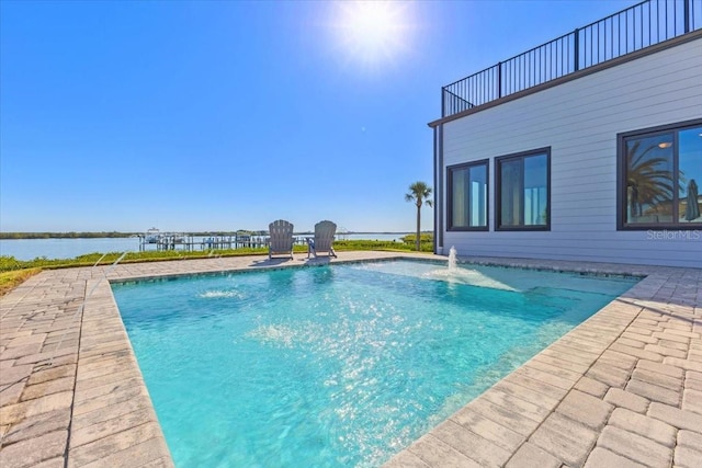 pool with a patio and a water view