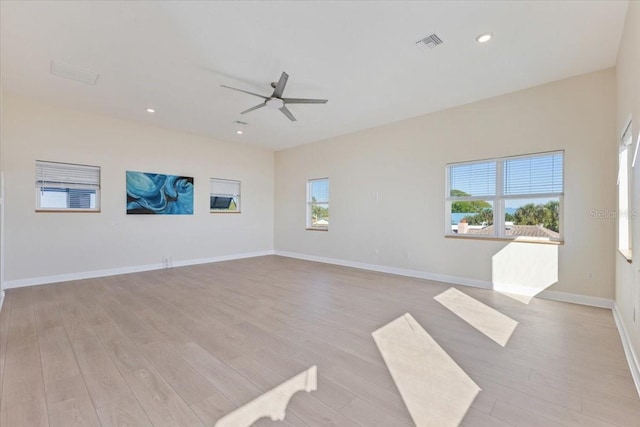 empty room featuring visible vents, a ceiling fan, recessed lighting, light wood finished floors, and baseboards