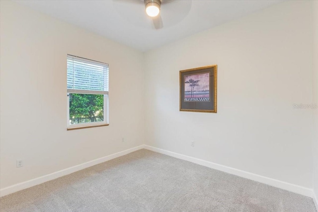 unfurnished room with carpet, a ceiling fan, and baseboards