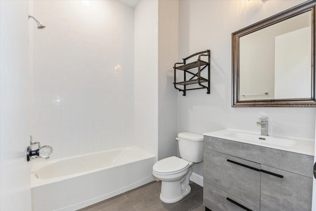 full bathroom with baseboards, toilet,  shower combination, and vanity