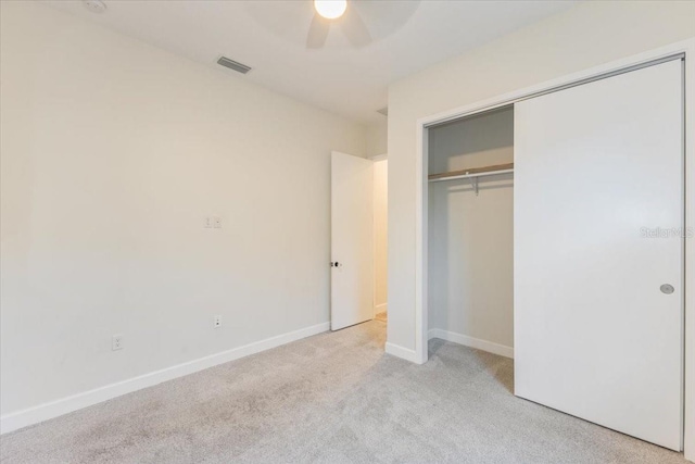 unfurnished bedroom with a ceiling fan, baseboards, visible vents, a closet, and carpet flooring