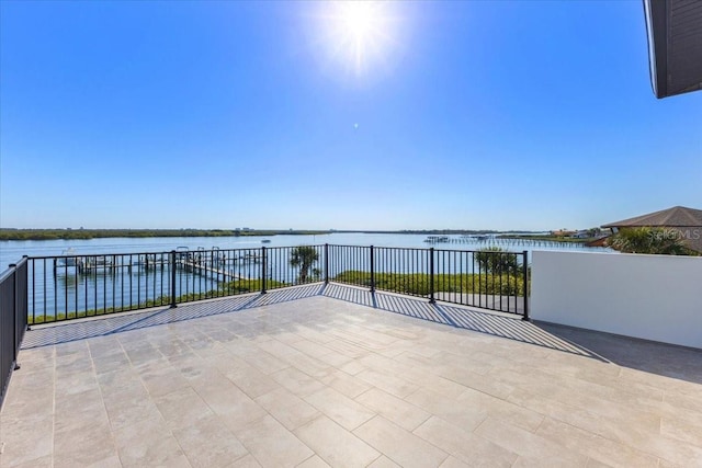 view of patio featuring a balcony and a water view