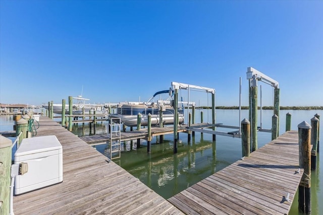 dock area featuring boat lift and a water view