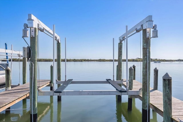 view of dock with boat lift and a water view