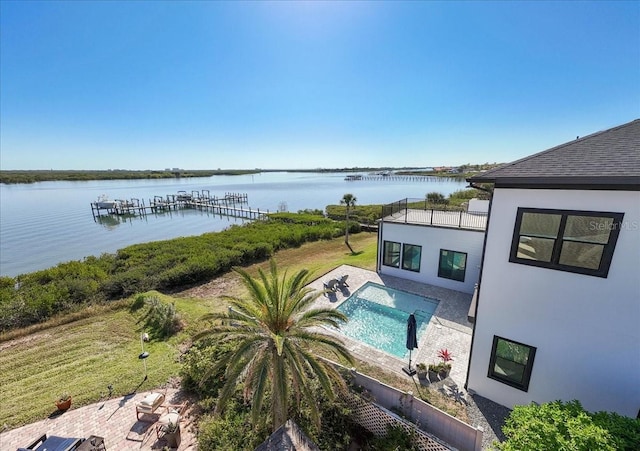 view of swimming pool featuring a patio area and a water view