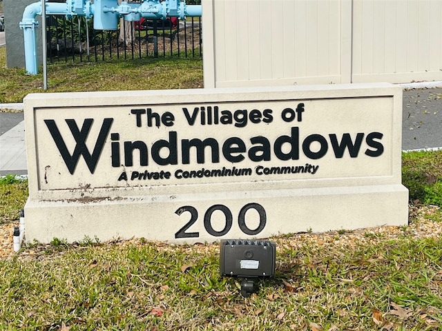 community / neighborhood sign with fence